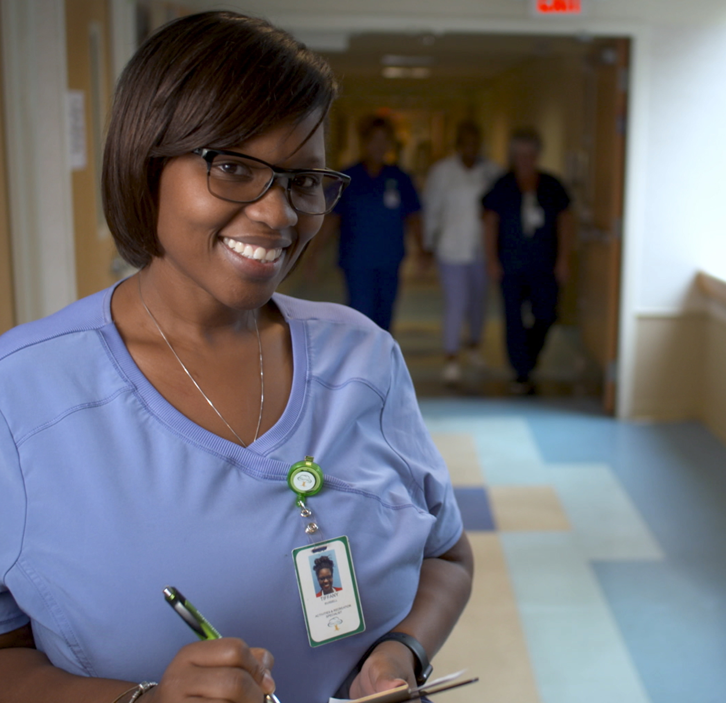 Employee walks with a Female Elderly Patient