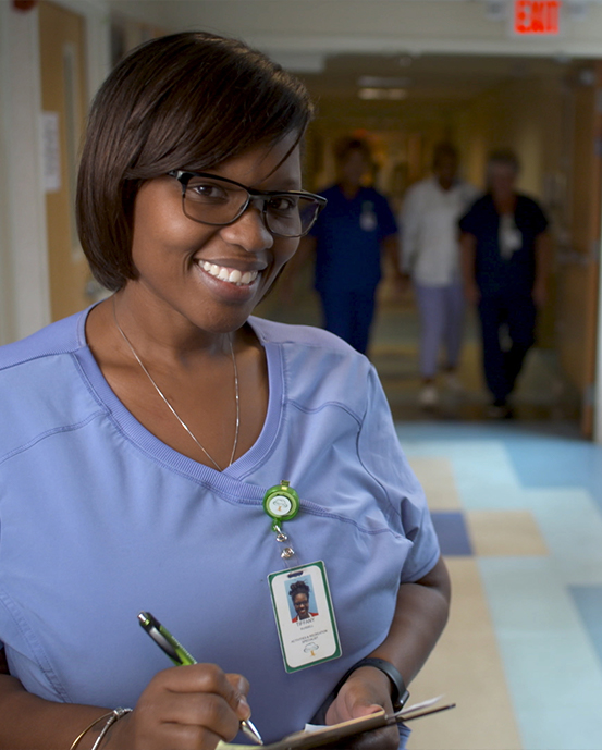 Employee walks with a Female Elderly Patient