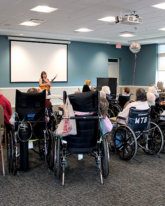 Employee walks with a Female Elderly Patient