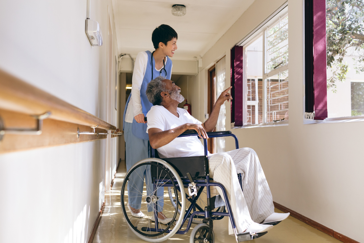 Employee walks with a Female Elderly Patient