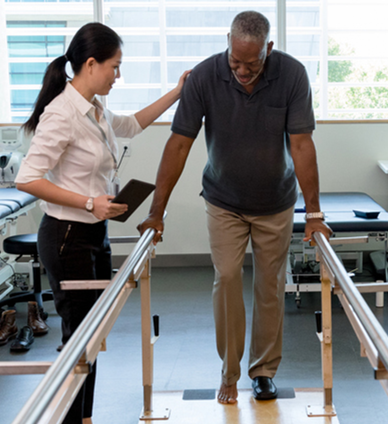 Employee walks with a Female Elderly Patient